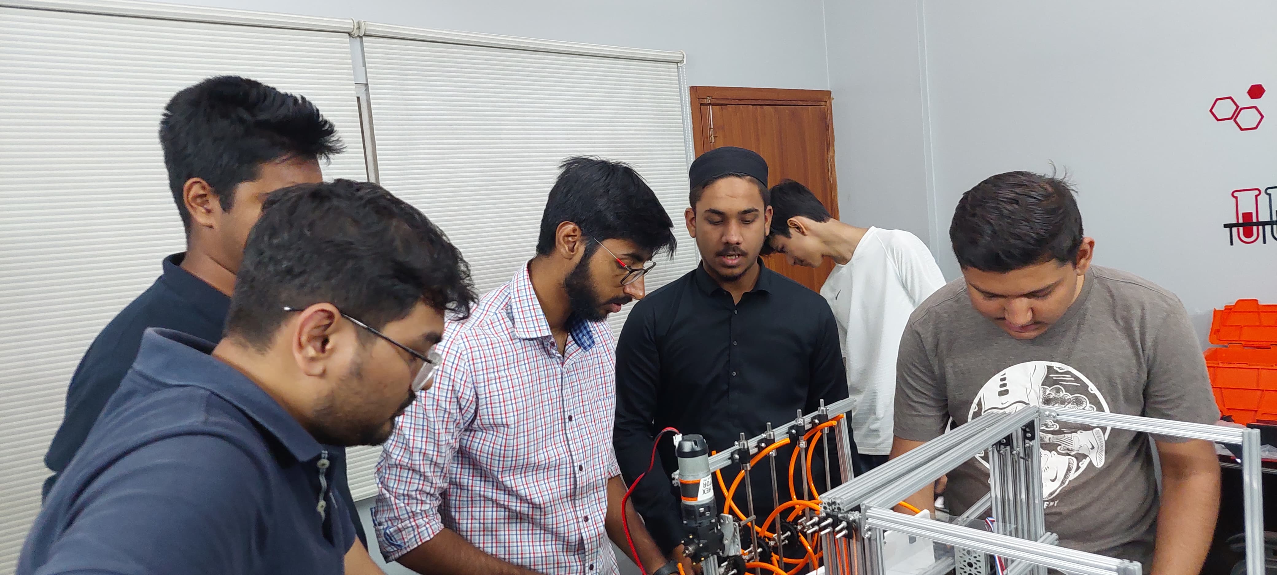 Robotics team members assembling a robot together